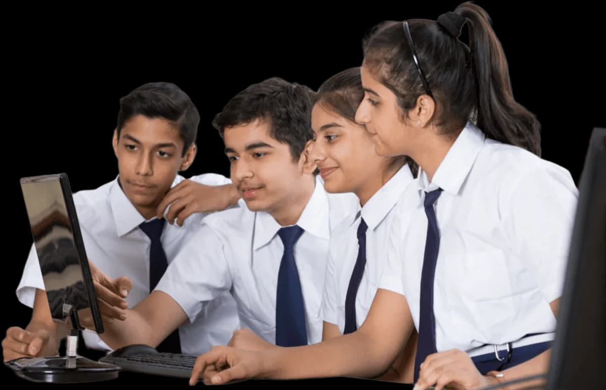 Four students in school uniform working together at a computer